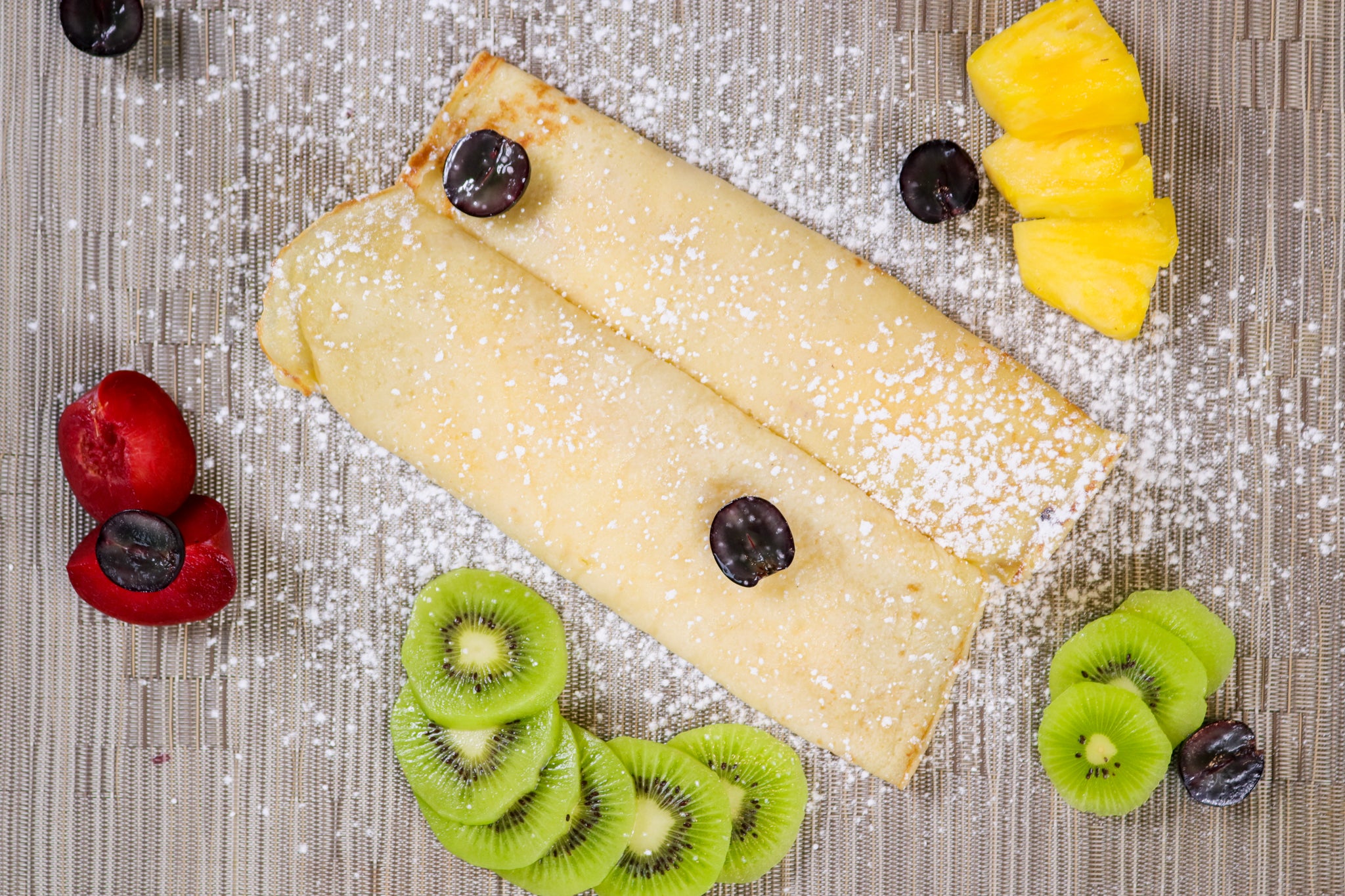 Crepe with fresh fruits and icing sugar