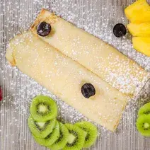 Crepe with fresh fruits and icing sugar