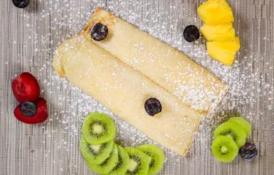 Crepe with fresh fruits and icing sugar Crepe with fresh fruits and icing sugar